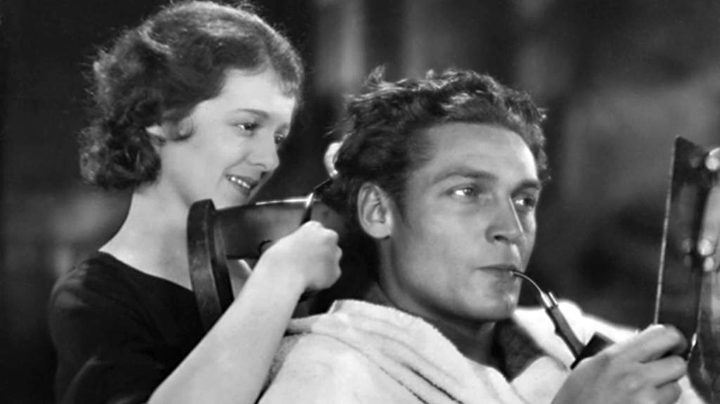 Diane (Janet Gaynor) cutting Chico's (Charles Farrell) hair. 