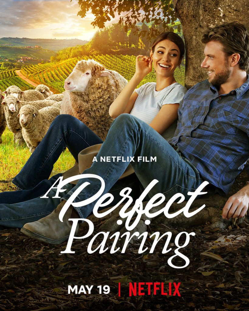 The film poster showing Lola (Victoria Justice) and Max (Adam Demos) sitting under a tree with sheep and a vineyard behind them. 