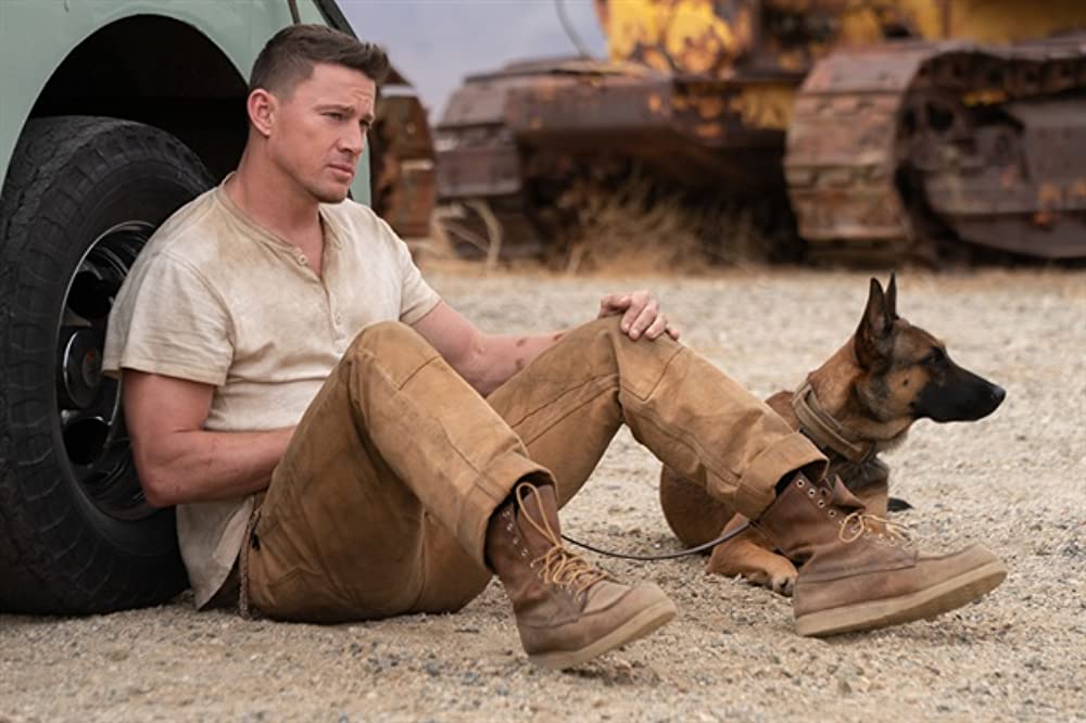 Jackson (Channing Tatum) sitting on the floor with Lulu. 