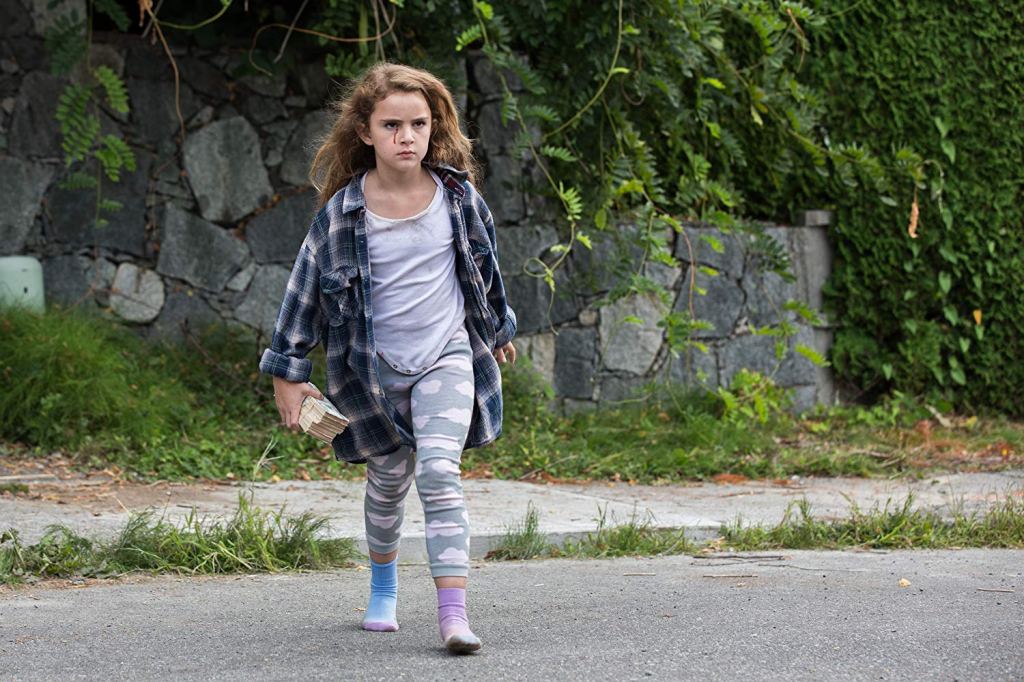 Chloe (Lexy Kolker) walking outside, cash in her hand and blood running from her eye.