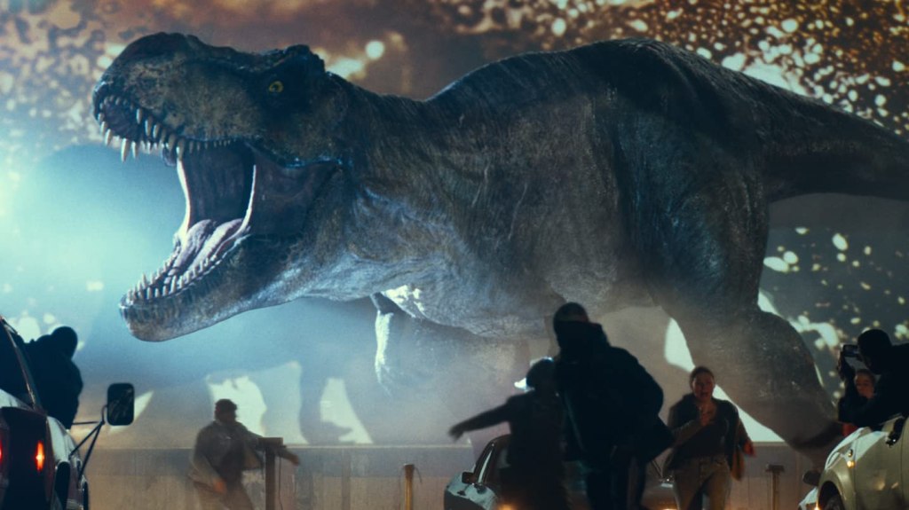 A t-rex screaming behind a group of fleeing people.