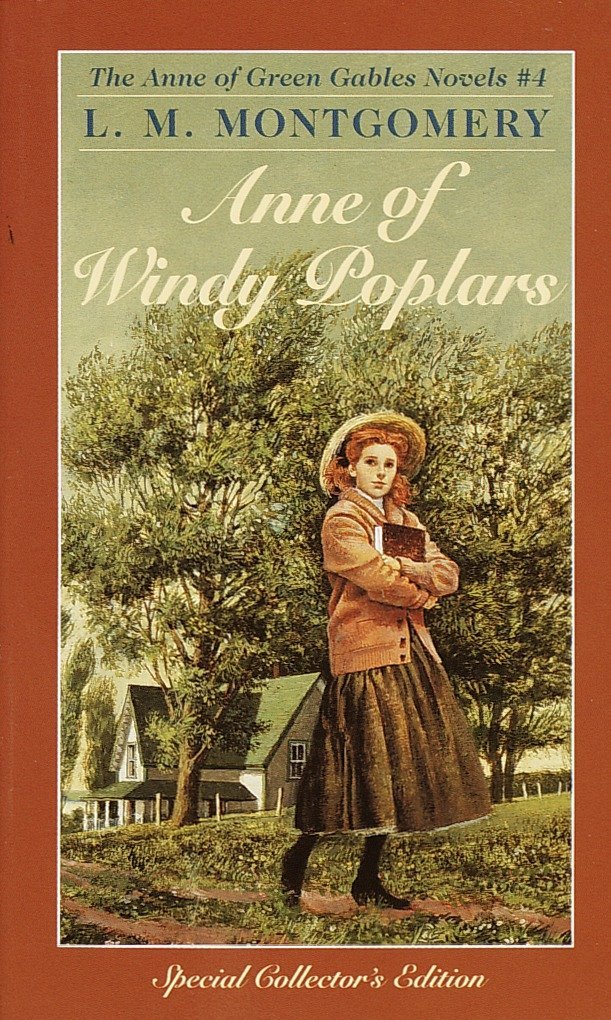 The book cover showing Anne holding a bookd standing in front of a house with a green roof.