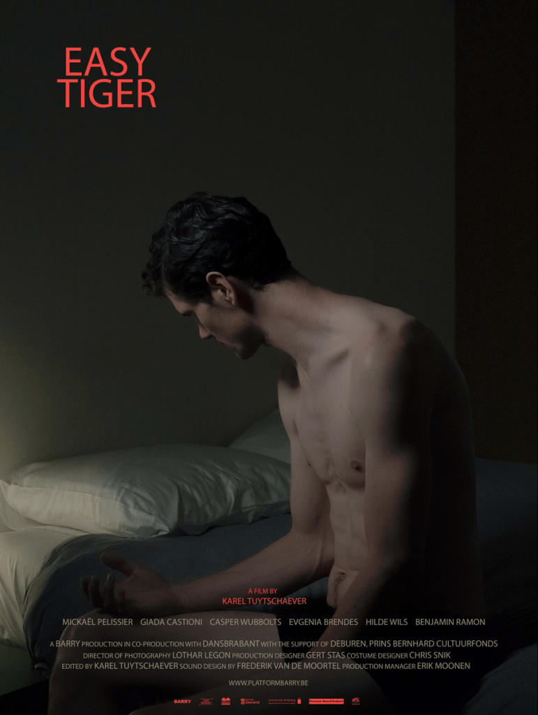 The film poster showing the Psychologist (Mickaël Pelissier) sitting on the edge of a bed, looking back and down dejectedly.