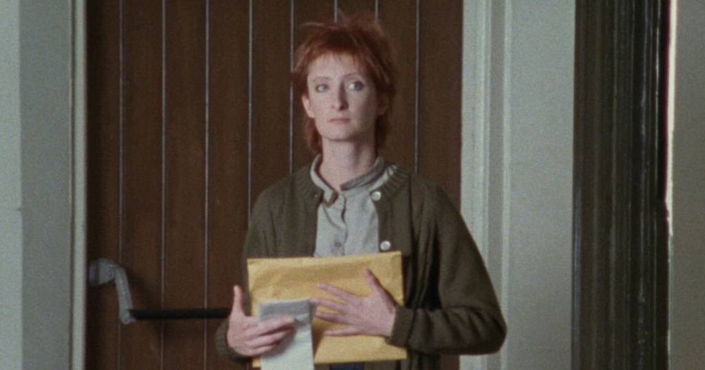 Polly (Sheila McCarthy) cradling a big envelope.