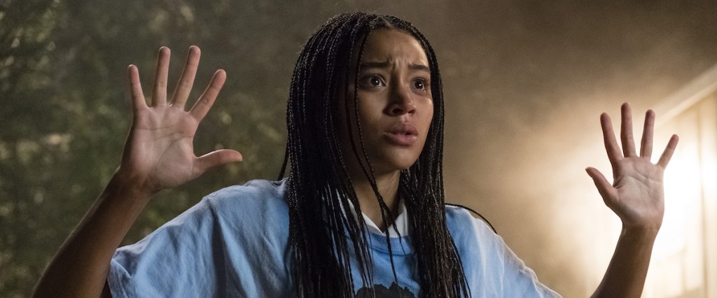 Starr (Amandla Stenberg) holding up her hands.