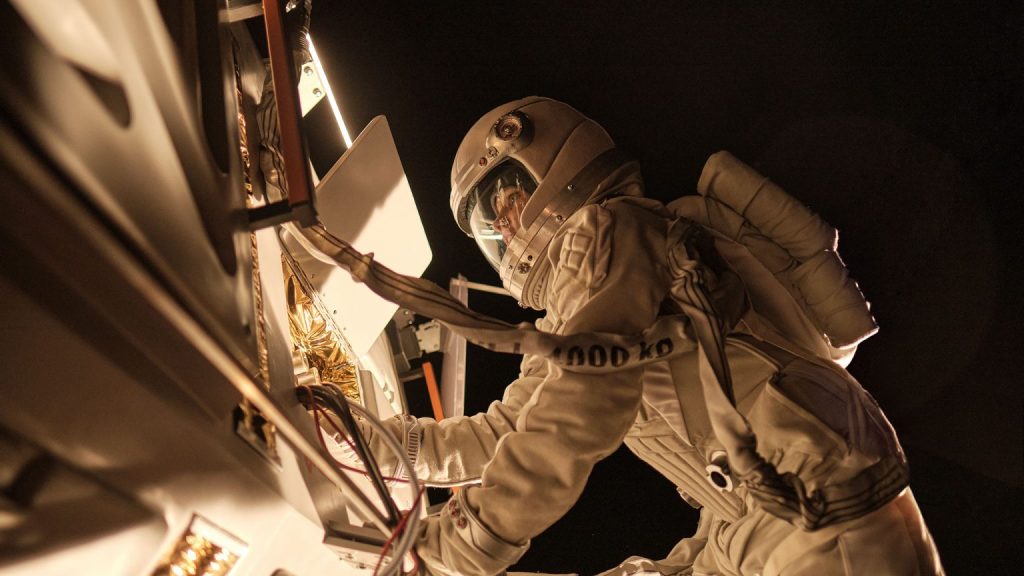 Hannah (Julia Franz Richter) working on the space station outside. 