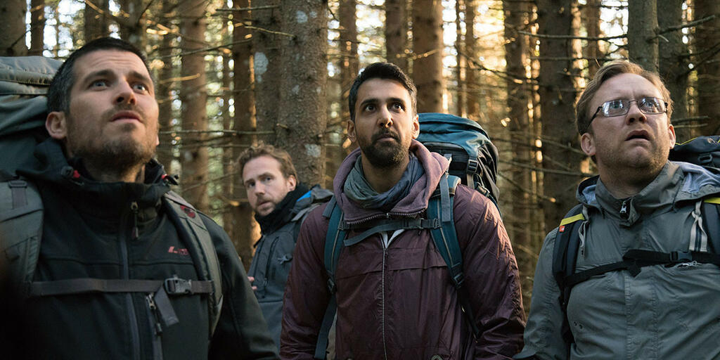Hutch (Robert James-Collier), Luke (Rafe Spall), Phil (Arsher Ali) and Dom (Sam Troughton) staring up at something.