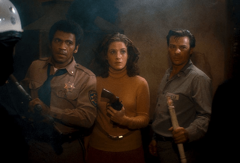 Police Officer Bishop (Austin Stoker), police secretary Leigh (Laurie Zimmer) and inmate Wilson (Darwin Joston) gearing up for a fight.