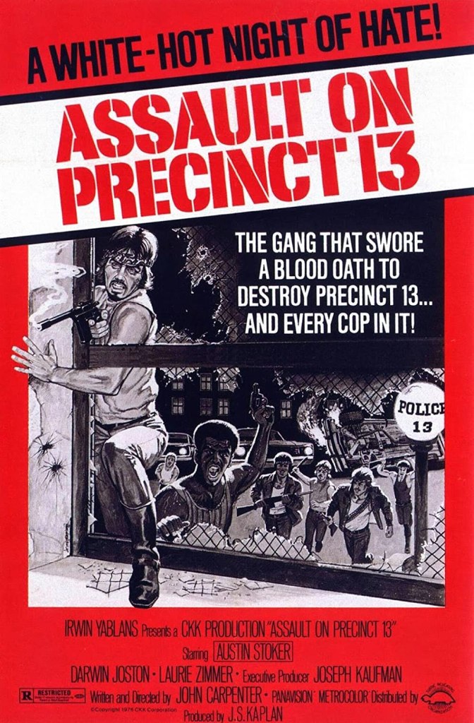 Tge film poster showing a gang rushing towards the broken window of Precinct 13.
