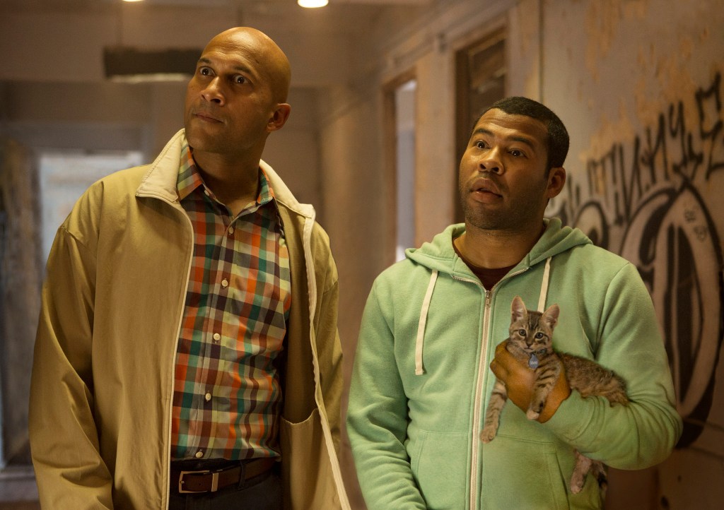 Clarence (Keegan-Michael Key) and Rell (Jordan Peele) looking very surprised. Rell is holding Keanu the kitten.