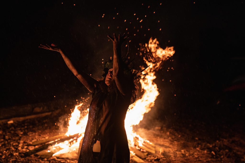 Mary (Derbhle Crotty) dancing in front of a bonfire.