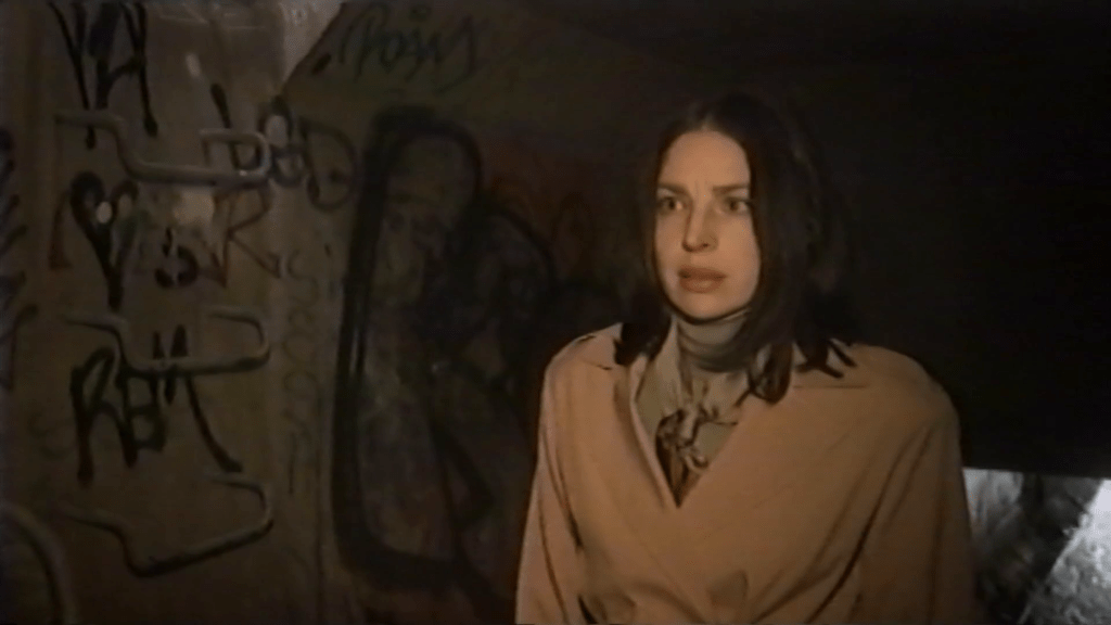 A woman standing in the sewers.