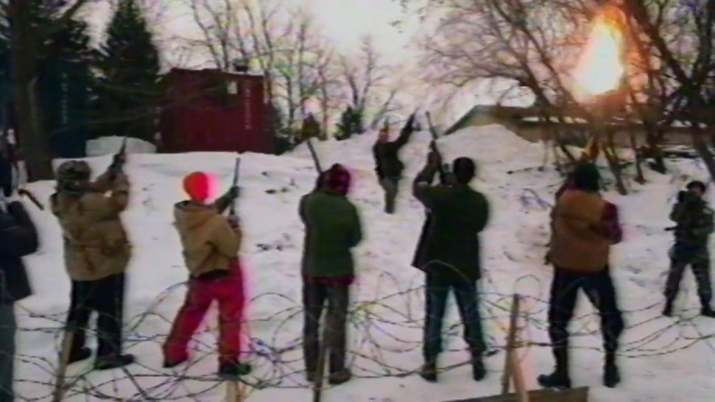 A group of men shooting guns.