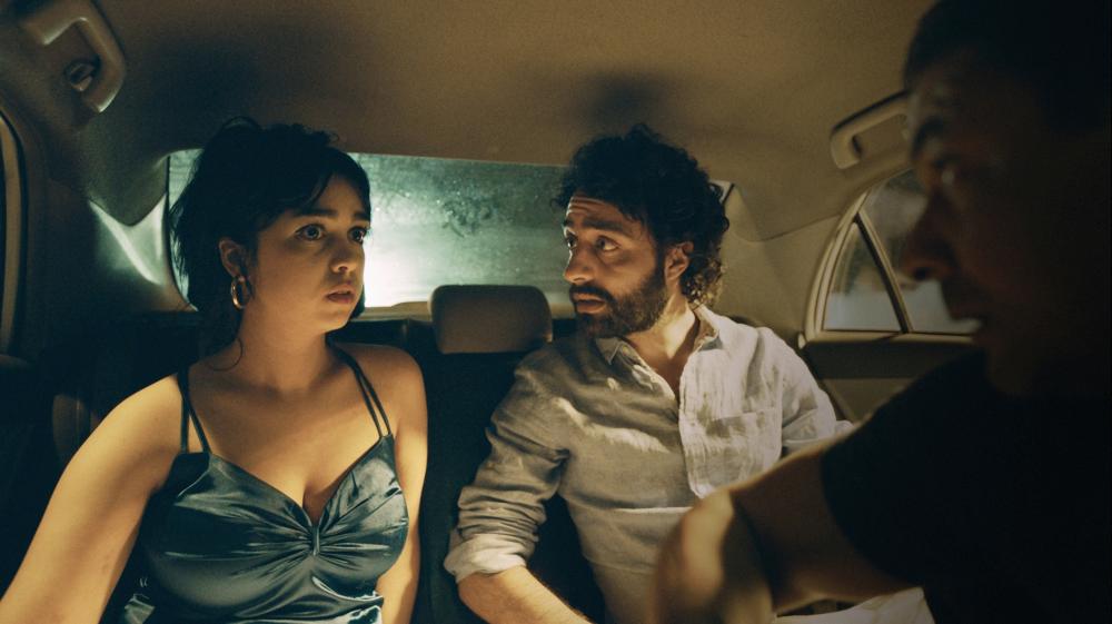 Mariam (Mariam Al Ferjani) and Youssef (Ghanem Zrelli) in a cab. 