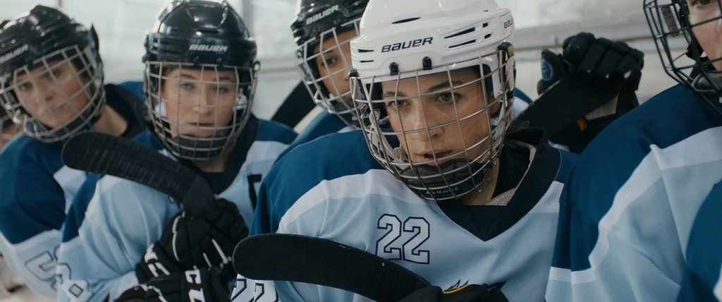 Threesa (Judith Altenberger) preparing to play ice hockey.