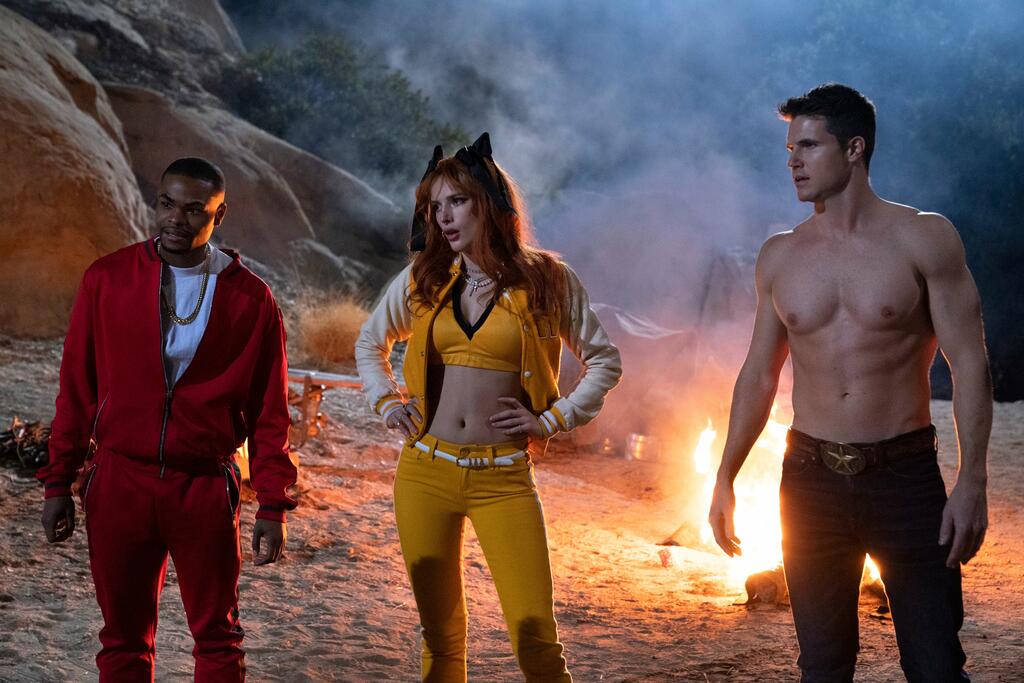 John (Andrew Bachelor), Allison (Bella Thorne) and Max (Robbie Amell) in front of a bonfire on the beach.
