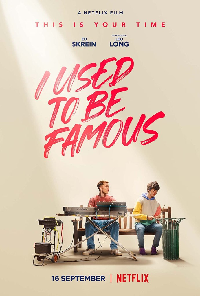 The film poster showing Vince (Ed Skrein) and Stevie (Leo Long) sitting on a park bench. Vince has a keyboard in front of him, Stevie is playing drums on a garbage can.