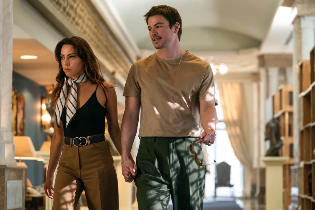 Sarah FIdel (Aubrey Plaza) and Danny Francesco (Josh Hartnett) walking hand-in-hand down a fancy corridor.