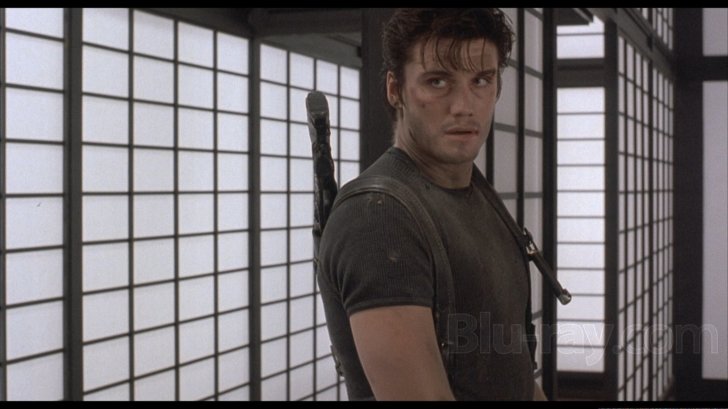 The Punisher (Dolph Lundgren) in the middle of a fight, taking a short break.