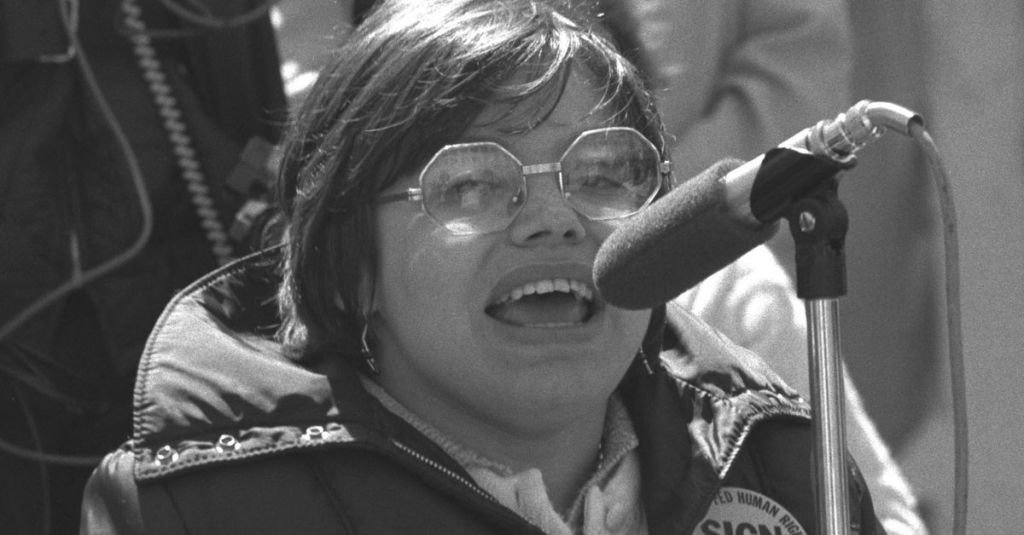 A young Judith Heumann giving a speech.