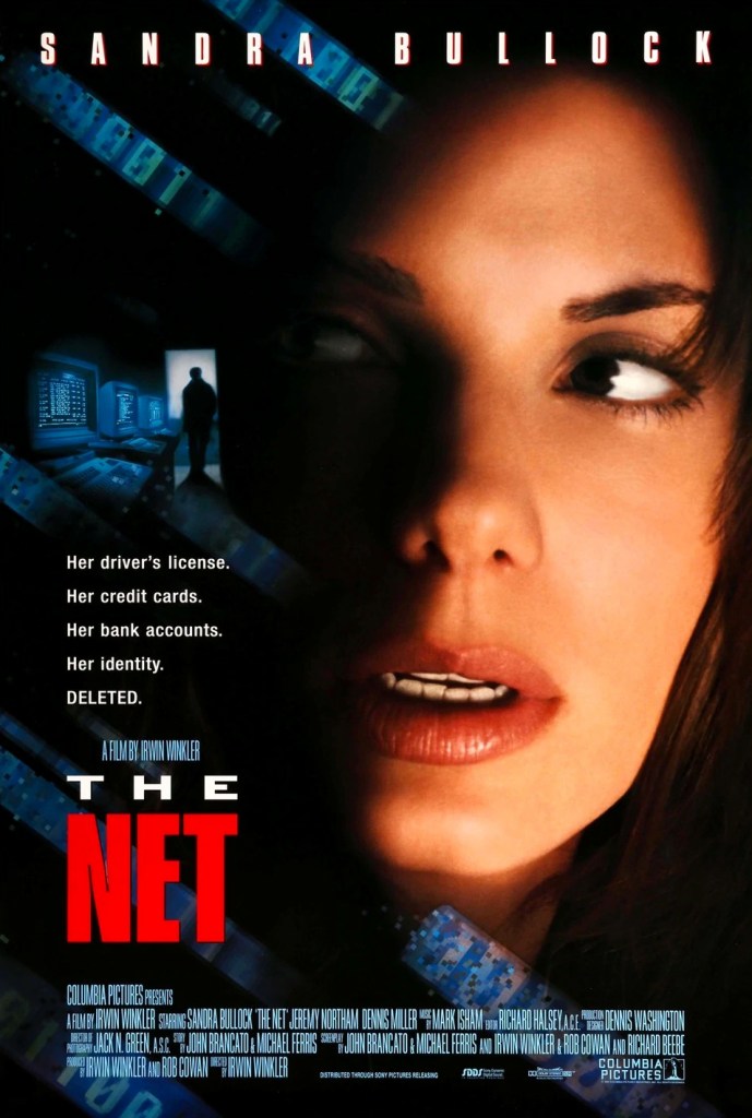 The film poster showing a close-up of Angela (Sandra Bullock), a few PCs and a shadowy figure in a doorway.