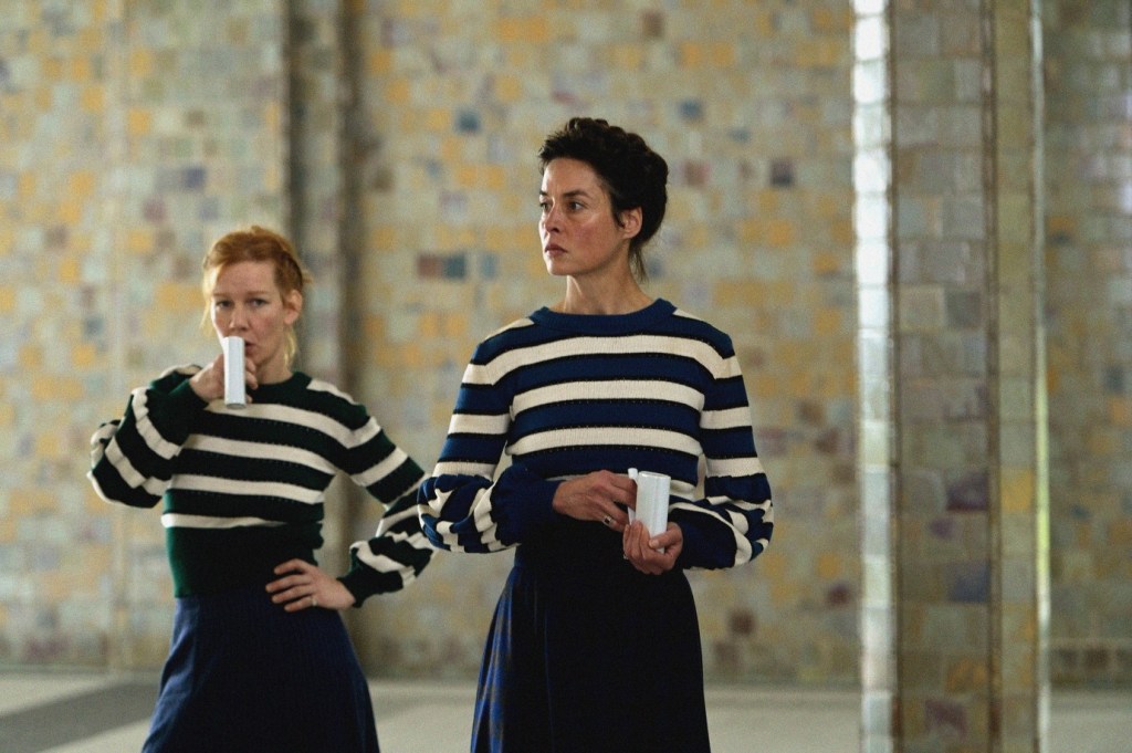Irma (Sandra Hüller) and Sisi (Susanne Wolff) drinking water from special cups.
