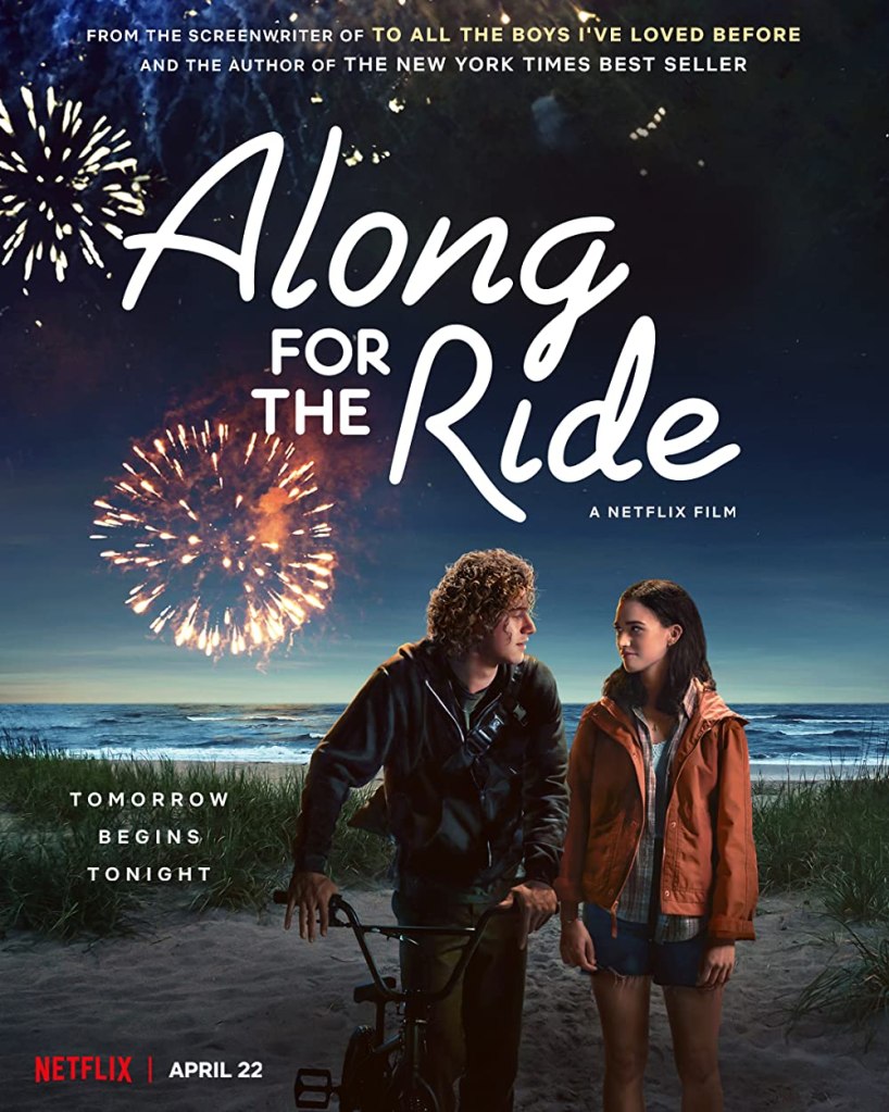 The film poster showing Auden (Emma Pasarow) and Eli (Belmont Cameli) on the beach at night. He is pushing a bike. They are looking at each other. Behind them are fireworks.