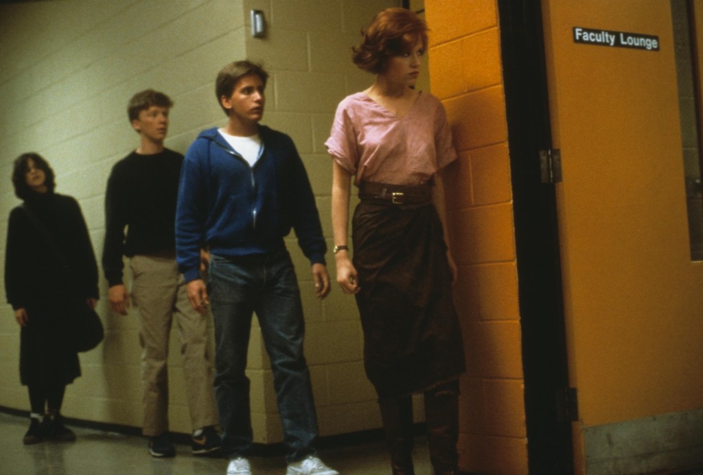 Claire (Molly Ringwald), Andrew (Emilio Estevez), Brian (Anthony Michael Johnson) and Allison (Ally Sheedy) sneaking toward the Faculty Lounge.