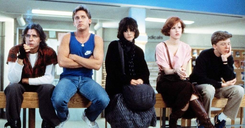 John (Judd Nelson), Andrew (Emilio Estevez), Allison (Ally Sheedy), Claire (Molly Ringwald) and Brian (Anthony Michael Johnson) sitting on a bar in the library.