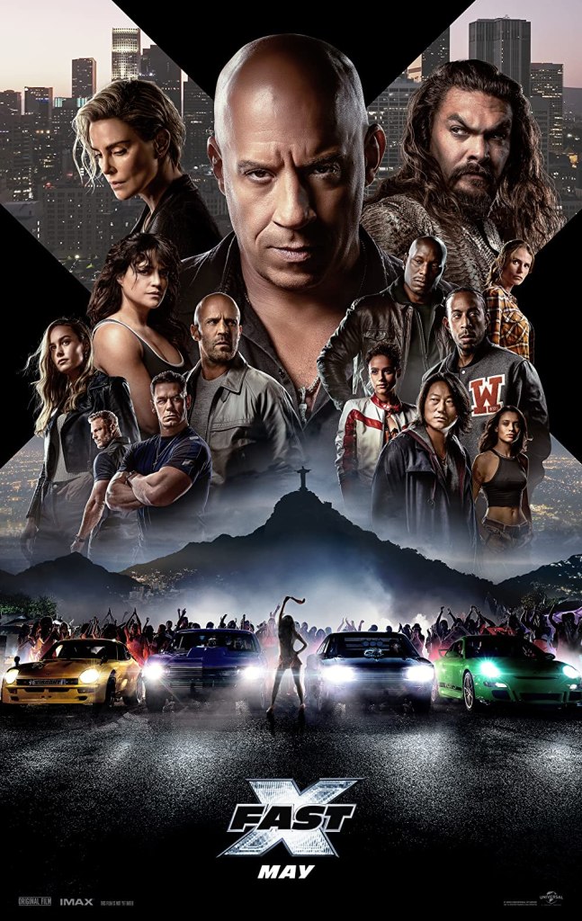 The film poster showing the main characters arranged inside the shape of an X over a street race start with four cars. 