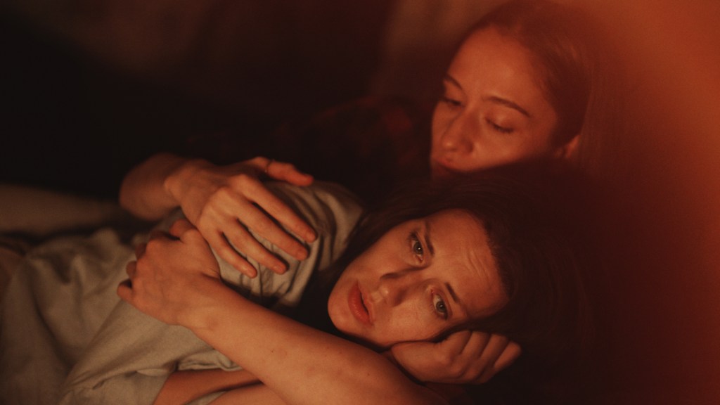 Mira (Eva Mores) holding Sarlota (Natalia Germani).