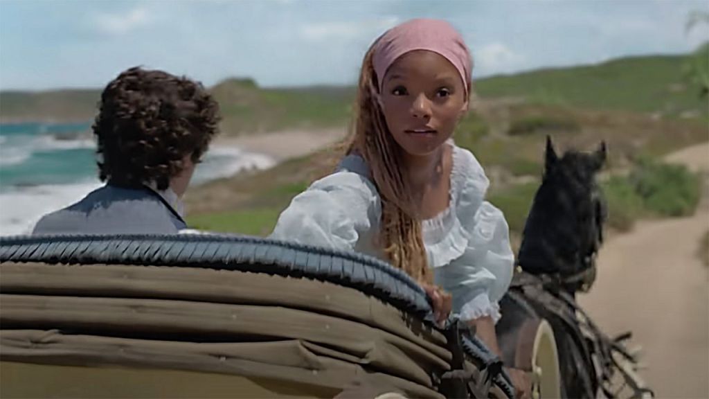 Ariel (Halle Bailey) on a carriage ride with Prince Eric (Jonah Hauer-King). 