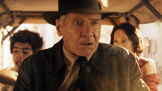 Indiana Jones (Harrison Ford) driving a Tuktuk with Teddy (Ethann Isidore) and Helena (Phoebe Waller-Bridge) behind him.