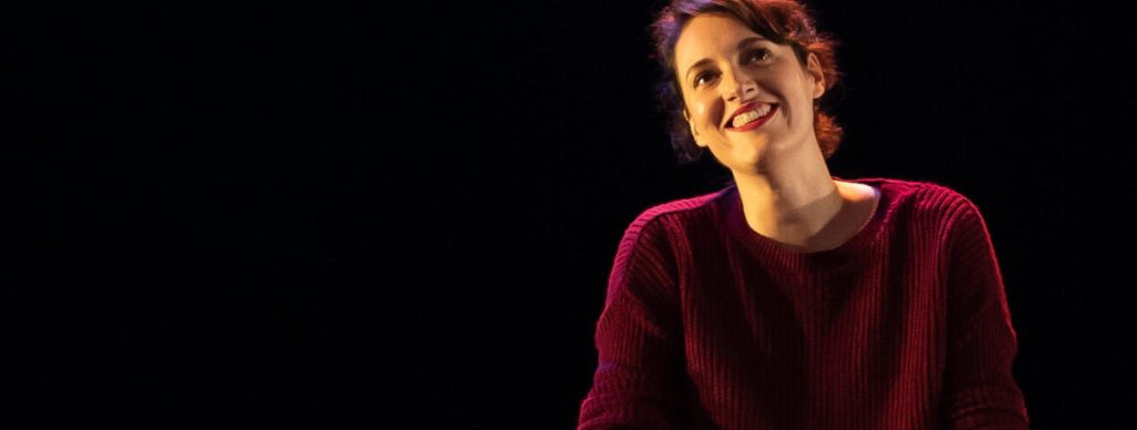 Fleabag (Phoebe Waller-Bridge)  smiling.