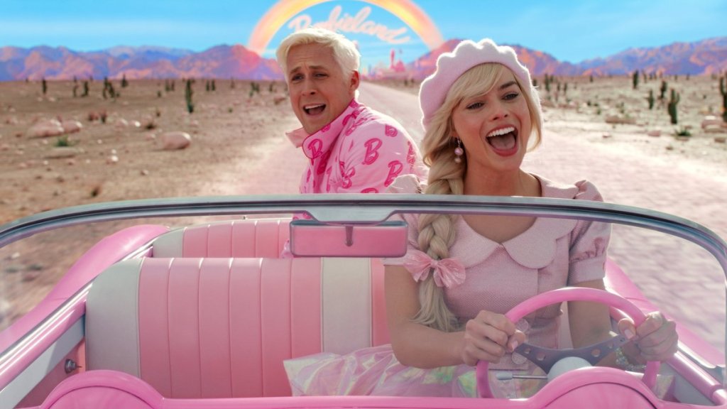 Barbie (Margot Robbie) driving out of Barbieland, Ken (Ryan Gosling) on the backseat.