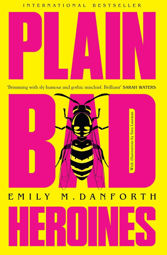 The book cover showing the title in big pink letters on a yellow background. Over the A of Bad, there is a yellowjacket.