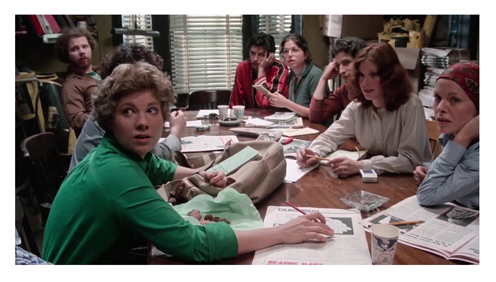 An editorial meeting, the staff sitting around the table.