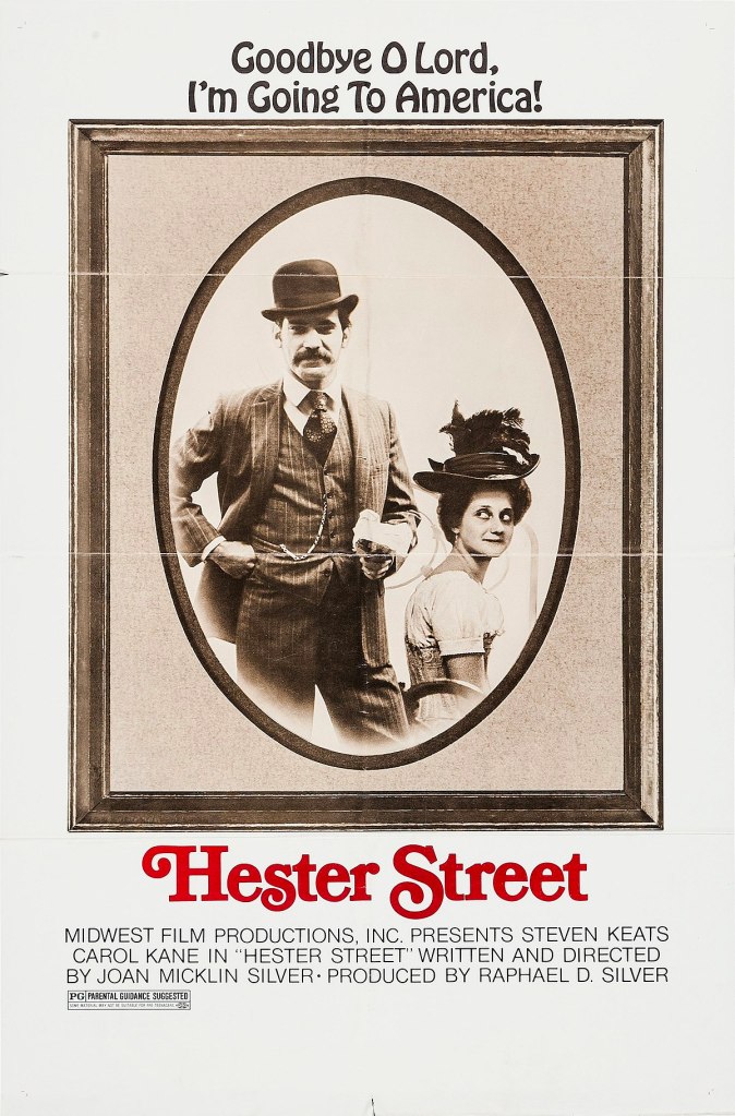 The film poster showing Jake (Steven Keats) standing next to Gitl (Carol Kane) framed as an old-timey portrait photo.