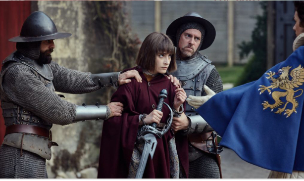 Royal guards holding Jennifer Strange (Ellise Chappell) back. 