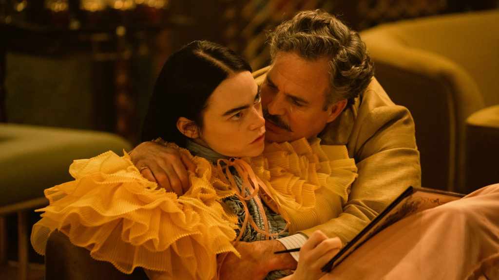 Bella (Emma Stone) looking aggravated as Duncan (Mark Ruffalo) hugs her.