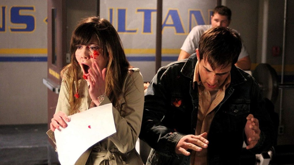 Wendy (Mary Elizabeth Winstead) and Kevin (Ryan Merriman) covered in blood spatter, looking shocked.