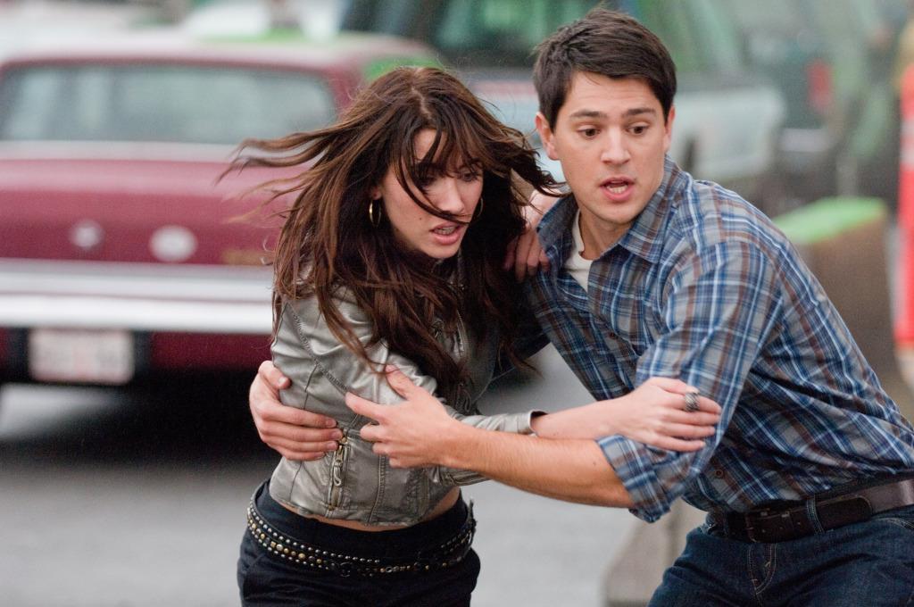 Sam (Nicholas D'Agosto) helpng Olivia (Jacqueline MacInnes Wood) on the bridge.