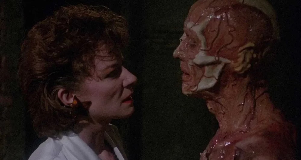 Julia (Clare Higgins) talking to a monstrous Frank (Sean Chapman/Oliver Smith). 