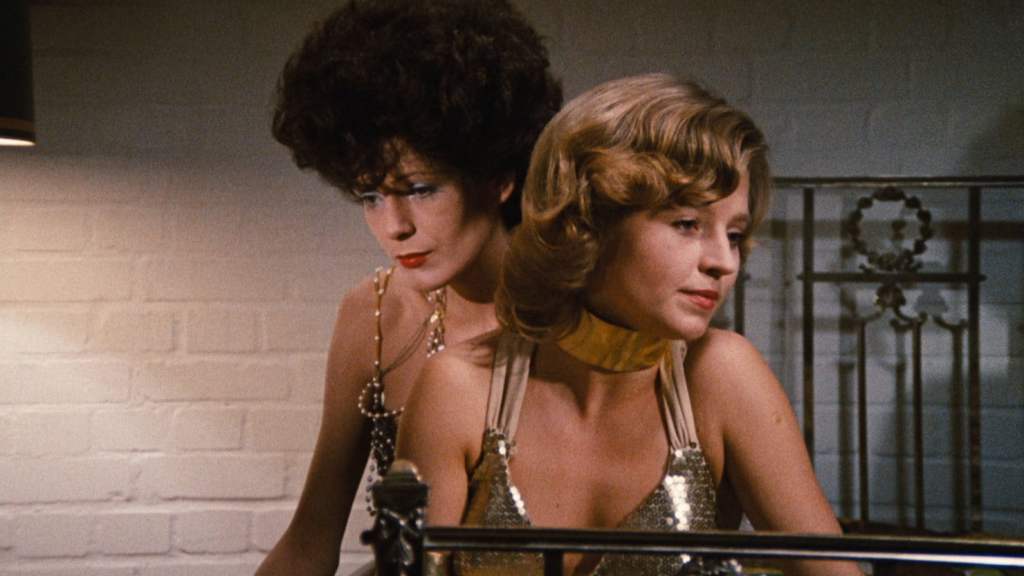 Petra (Margit Carstensen)  and Karin (Hanna Schygulla) sitting on the bed looking in different directions.