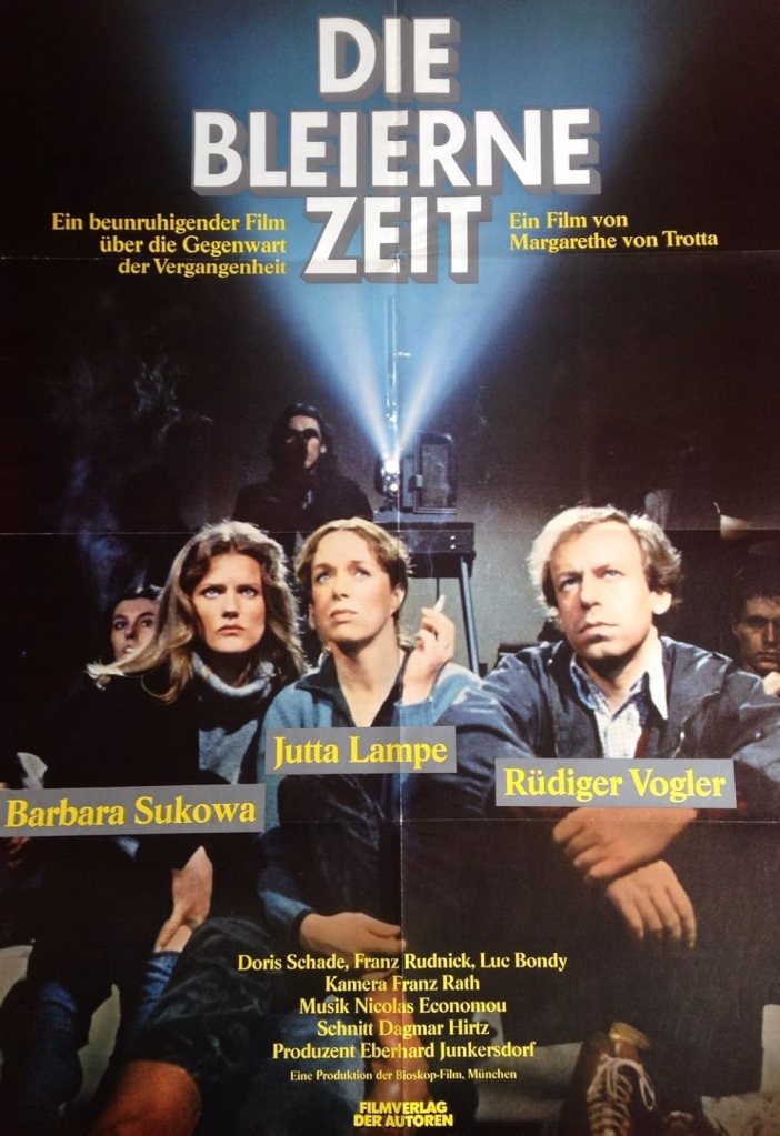 The film poster showing Marianne (Barbara Sukowa), Juliane (Jutta Lampe) and Juliane's boyfriend (Rüdiger Vogler) sitting on the floor watching a movie projected from behind them.