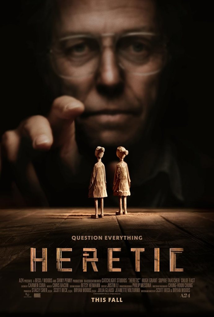 The movie poster showing Mr. Reed (Hugh Grant) in the background grasping for two female wooden figurines in the front.