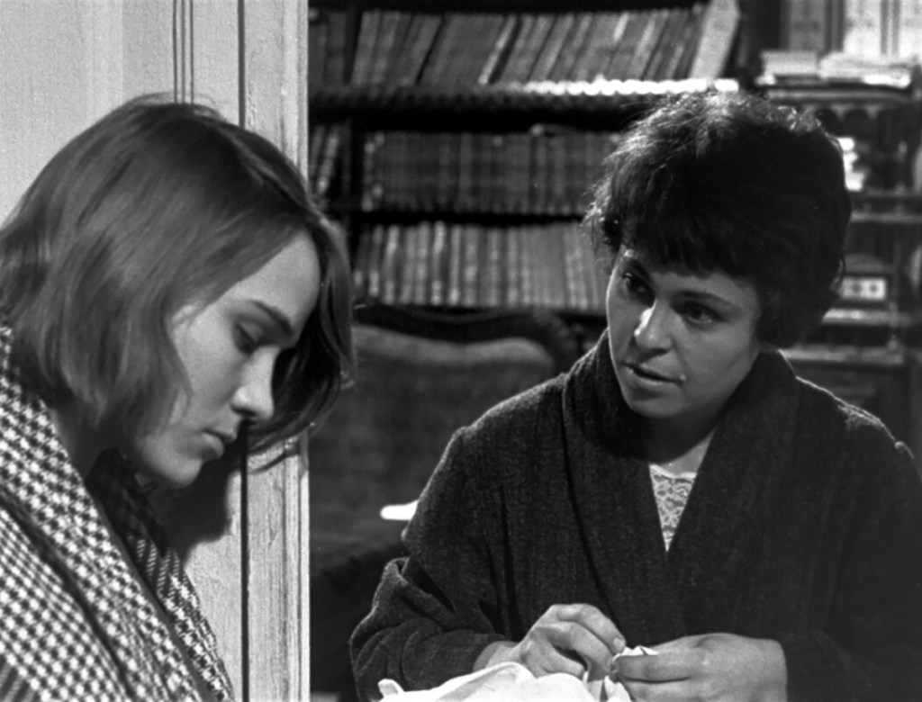 Nadia (Nina Ruslanova) bowing her head as Valentina (Kira Muratova) speaks to her.