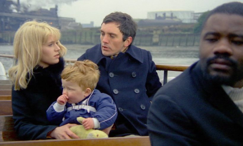 Joy (Carol White) and Dave (Terence Stamp) on a ferry boat with Joy's son.