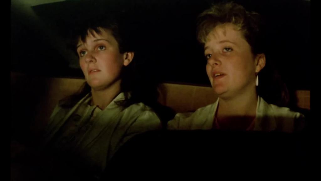 Rita (Siobhan Finneran) and Sue (Michelle Holmes) sitting in a cinema, looking pretty bored.