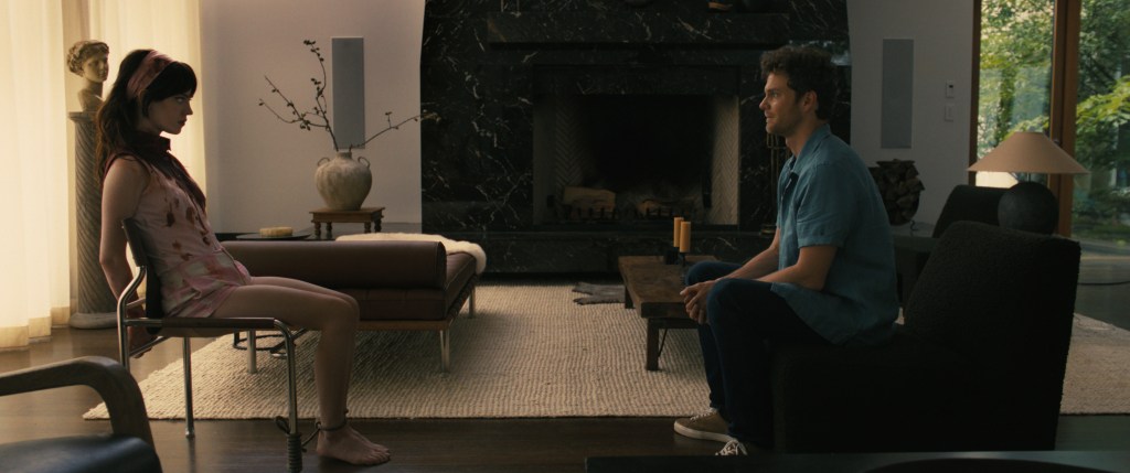 Iris (Sophie Thatcher) tied to a chair, facing Josh (Jack Quaid).